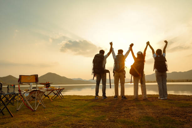 istock Four adult friends looking out from river waterfront, 1434632540