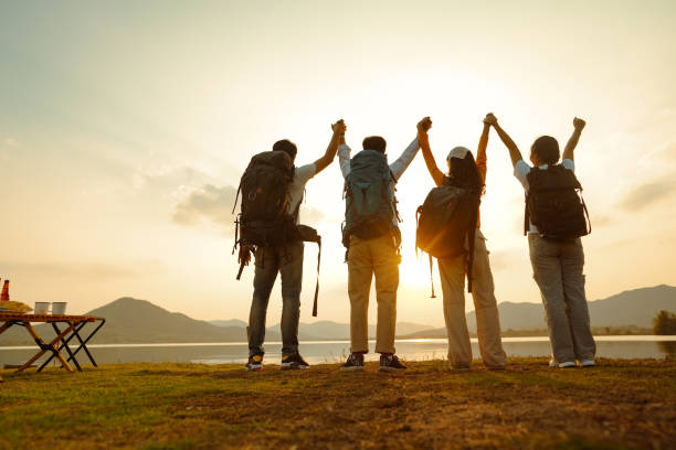 istock Four adult friends looking out from river waterfront, 1434632560