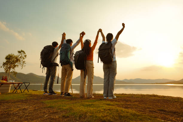 istock Four adult friends looking out from river waterfront, 1434632571