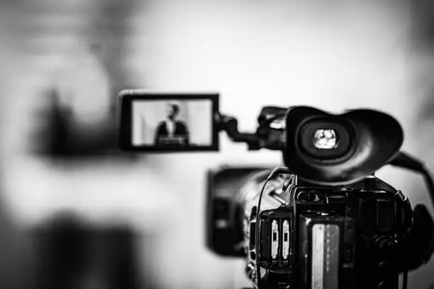 Photo of Camera Recording at a Press Conference.