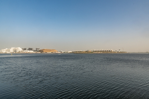 The canal and buildings in Al Raha Beach neighbourhood in Abu Dhabi. Al Raha is a mixed-use development with waterfront apartments and a popular leisure destination in Abu Dhabi. It has 11 sub-communities such as Al Zeina, Al Muneera and Al Bandar.