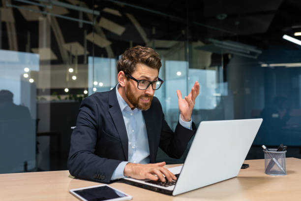 istock Angry mature boss got error laptop not turning on, program not working, senior man working on computer inside modern office building, businessman in glasses and business suit 1434635978