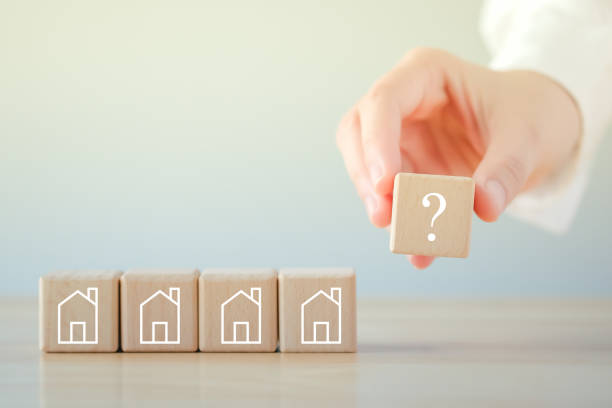 real estate, property investment and asset management concept. hand holding question mark and  house on wooden blocks. decision to choose the best property with your right. choosing suitable housing. - house human hand choice real estate imagens e fotografias de stock
