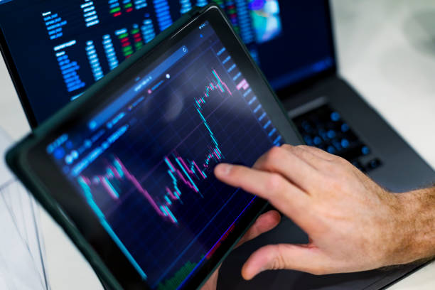 istock Closeup of hands with digital tablet screen with cryptocurrency graph 1434638529