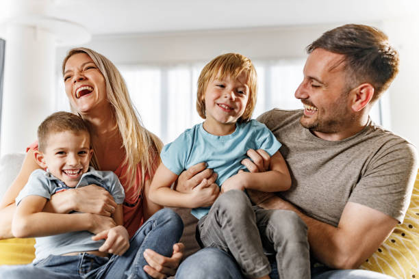 istock Cheerful parents having fun with their sons at home. 1434638620