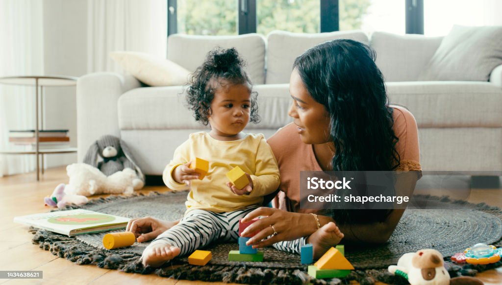 Learning, building and mother and baby on a carpet, playing, relax and bonding on a floor together. Family, child development and girl enjoy fun game with color blocks and happy parent in living room Baby - Human Age Stock Photo