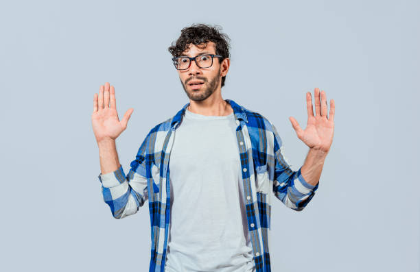 istock Scared bearded man with raised hands in front. Scared and horrified man with raised palms, Man with a frightened face with his hands raised in front. Portrait of scared person with raised hands 1434639048