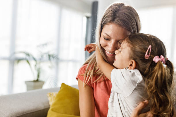 istock Affectionate girl embracing her single mother at home. 1434639291