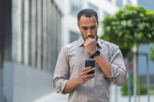 istock Thinking and sad muslim businessman reading message from smartphone, man outside office building using phone depressed reading bad news. 1434640612