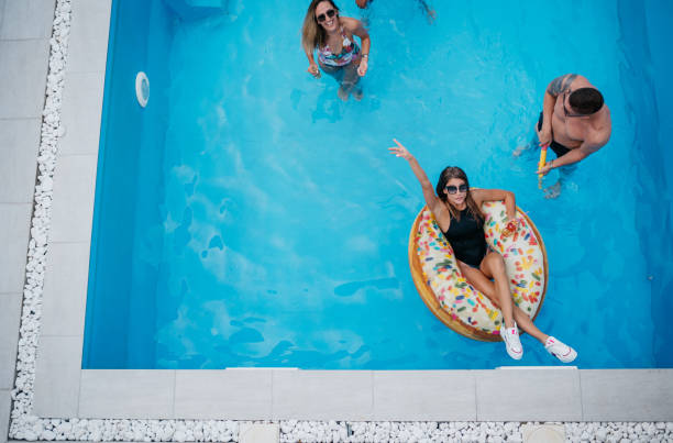 istock Happy friends having fun at the swimming pool 1434641094