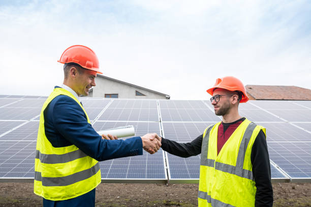 istock workers on installation of solar economical panels shake hands after work. 1434642566