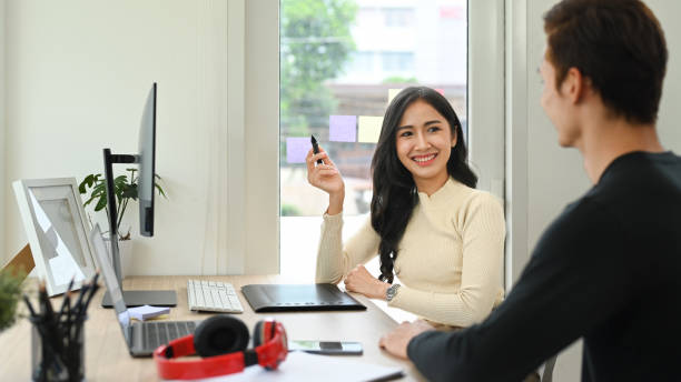 istock Cheerful young creative woman brainstorming, working together for design project at modern office. 1434644804