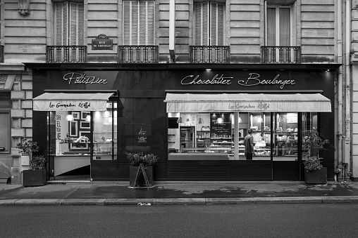 Paris, France – May 26, 2022: A grayscale of a bakery in Paris in early the morning, France
