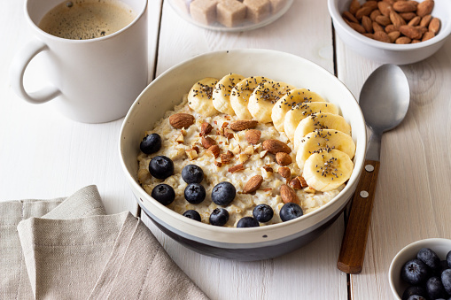 Oatmeal with banana, blueberries, almonds and honey. Healthy food. Vegetarian food.