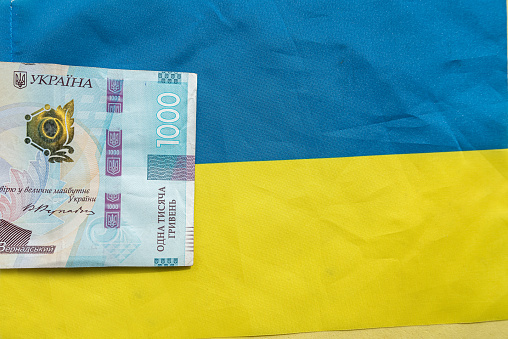 Ukrainian Money on national flag blue yellow, finance conccept. Uah hrn gryvnia