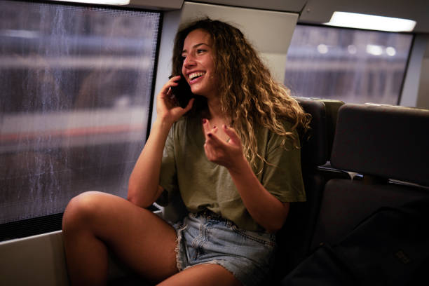 istock Happy smiling woman using the phone while travel by train 1434648591