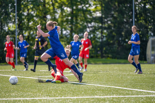 giocatore femminile che calcia la palla - football field football number 20 grass foto e immagini stock