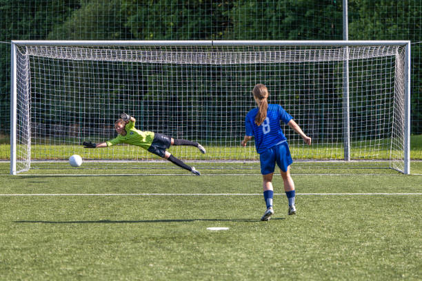 istock Female goalkeeper trying to catching ball 1434650528