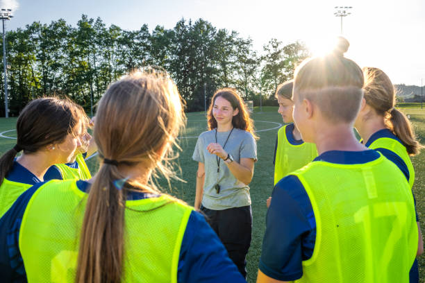 istock Coach instructing to football players 1434650542