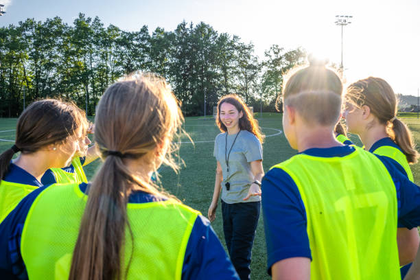istock Coach instructing to football players 1434650545