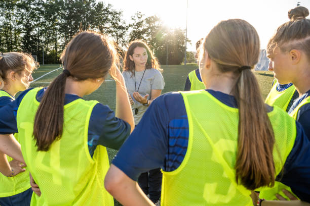 istock Coach instructing to football players 1434650556