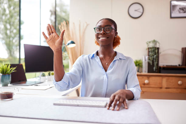 istock Woman Working From Home Office Sitting At Desk Interacting With AR Or VR Technology On Video Call 1434650832