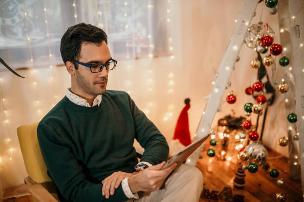 istock Modern young man using tablet at home for Christmas 1434651220