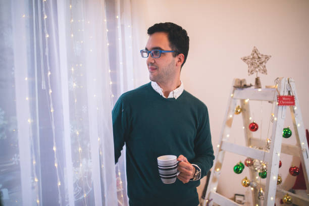 istock Attractive man drinking tea on Christmas morning 1434651956