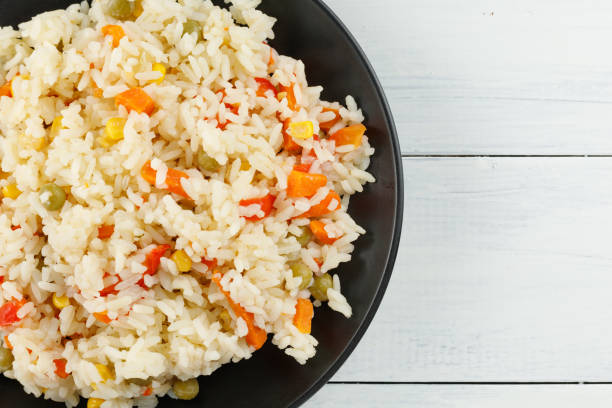 istock Rice with vegetables in a plate on the table. place for text cope 1434652323