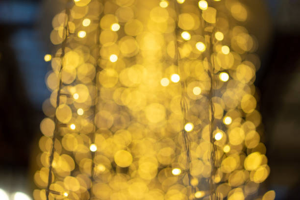 istock Yellow glitter blur and defocus light on dark background for celebration event card. 1434652636