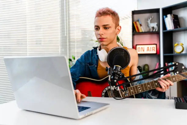 Photo of Blogger and radio host playing a song and singing for some of his fans during a live podcast for social media