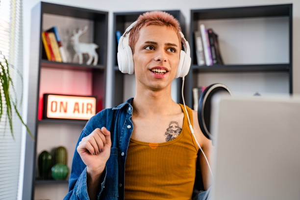 istock transgender person with microphone is recording podcast at home or studio 1434656111