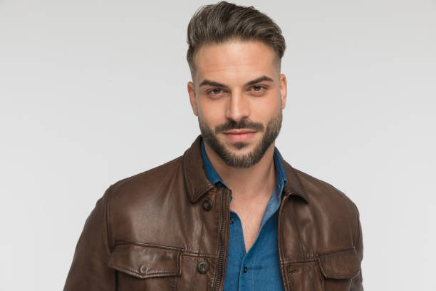 istock portrait of attractive young man with beard smiling in studio 1434656449