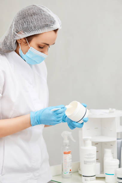 istock Beautician holding white plastic jar with cream 1434657669