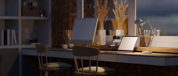 istock Comfortable home workspace at night with laptop mockup, table lamp on table 1434658229