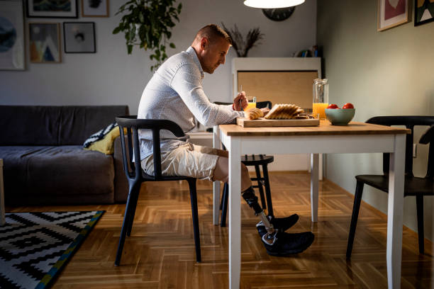 istock Young man with physical disability enjoying morning meal 1434658288