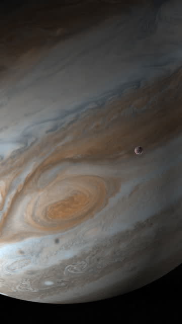 Jupiter planet and satellite Ganymede in the outer space. 4K Vertical