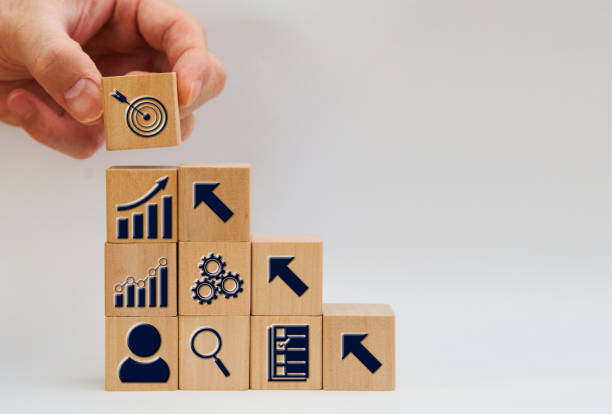 istock wood block with business growth develop corporate gear data step chart bar and goal signs in success teamwork concept 1434660080