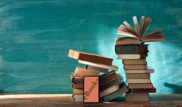 istock e book concept with stack of books and e book reader on teal background, good copy space 1434662800