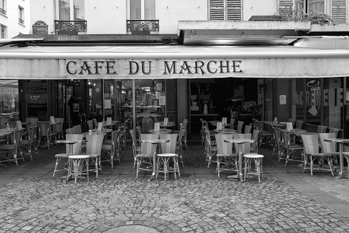 Paris, France – May 26, 2022: A closeup grayscale of Cafe du Marche outdoors, Paris