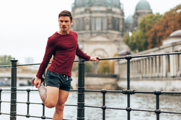 istock fitness man doing stretching in the park 1434665197