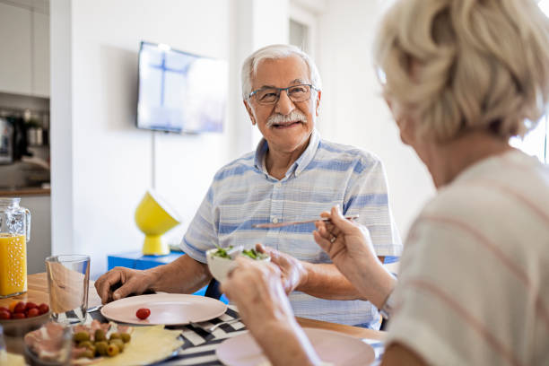 istock Smiling senior couple having breakfast together at home 1434666647