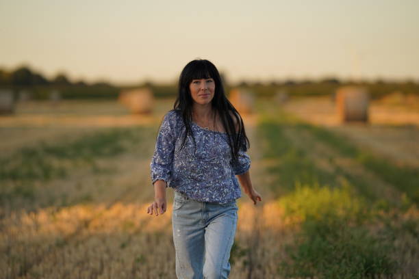 istock A drunken slightly drunk pretty woman with a bare shoulder with a smile walks through the countryside, a man after a merry booze. 1434669765