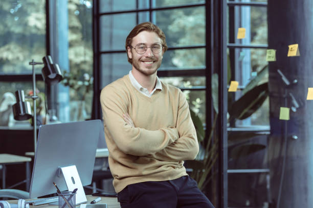 istock Portrait of successful young IT specialist young engineer programmer modern loft office. 1434669905