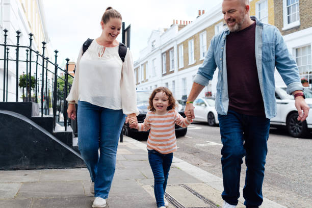istock Parents and son holding hands while walking in the city 1434670461