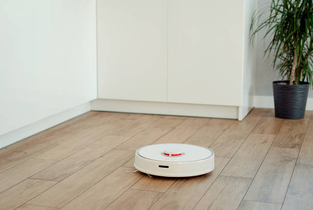istock White robot vacuum cleaner washes the floor 1434673520