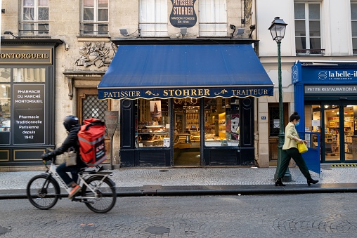 Paris, France – May 29, 2022: The Stohrer Patisserie store with people in the foreground, Paris, France