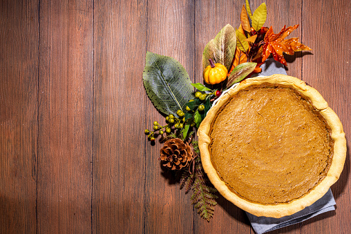 Traditional thanksgiving day american holiday pumpkin pie, traditional pastry cake on wooden table