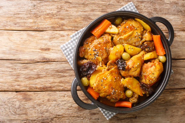 istock Gallo en chicha is a rooster cooked in a fermented corn drink with vegetable and spices closeup on the pan. Horizontal top view 1434676626