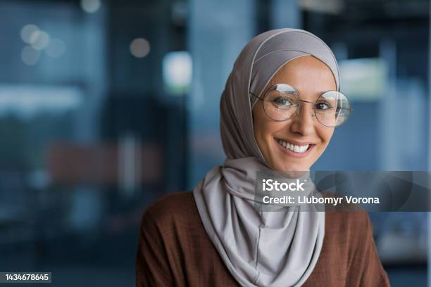 Close up photo portrait of beautiful young muslim woman, woman in hijab and glasses